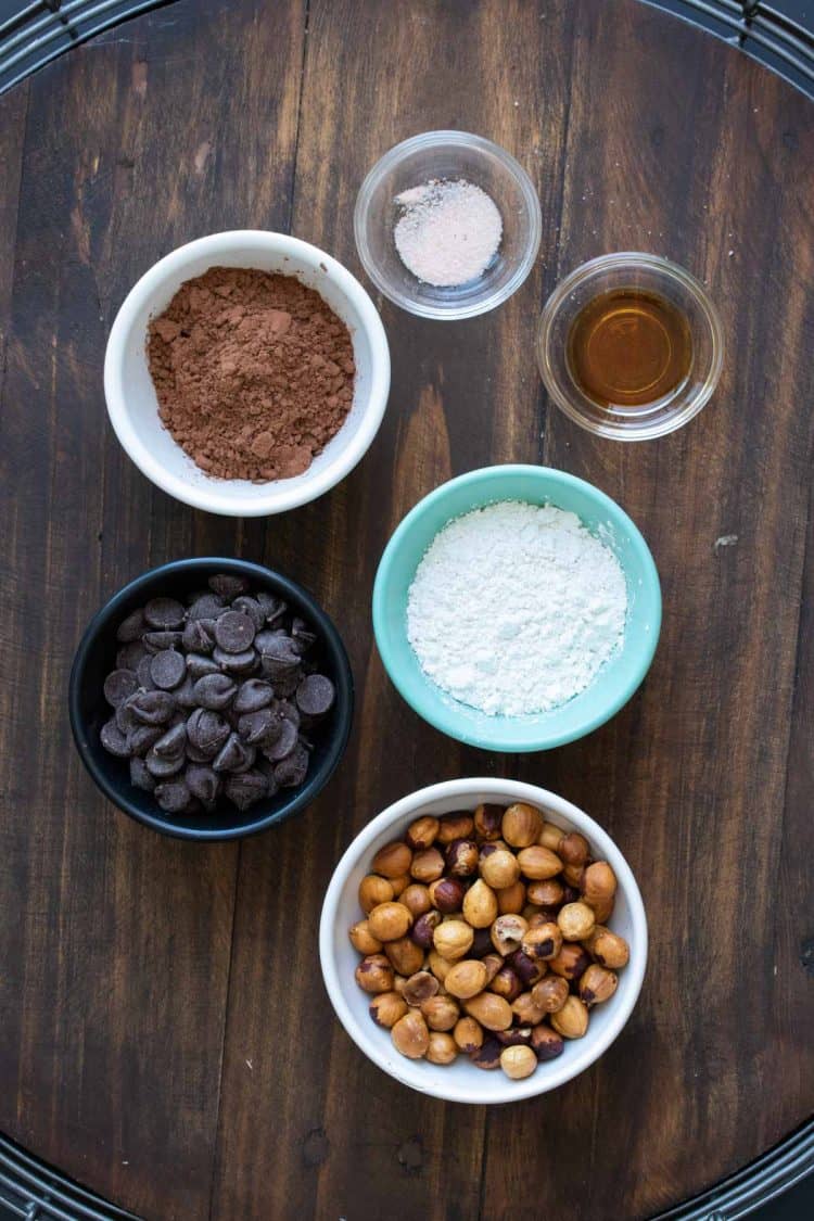 Ingredients to make homemade Nutella in different colored bowls