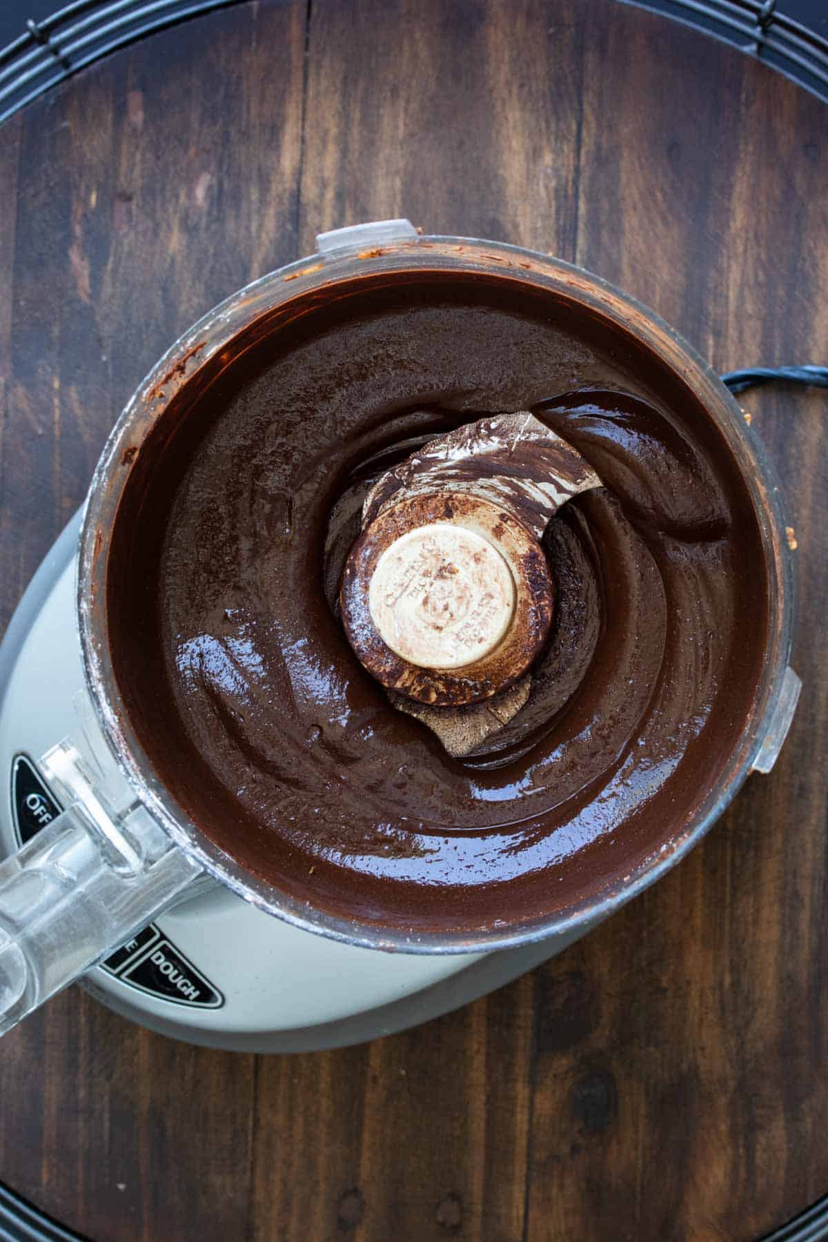 Top view of a food processor filled with blended Nutella