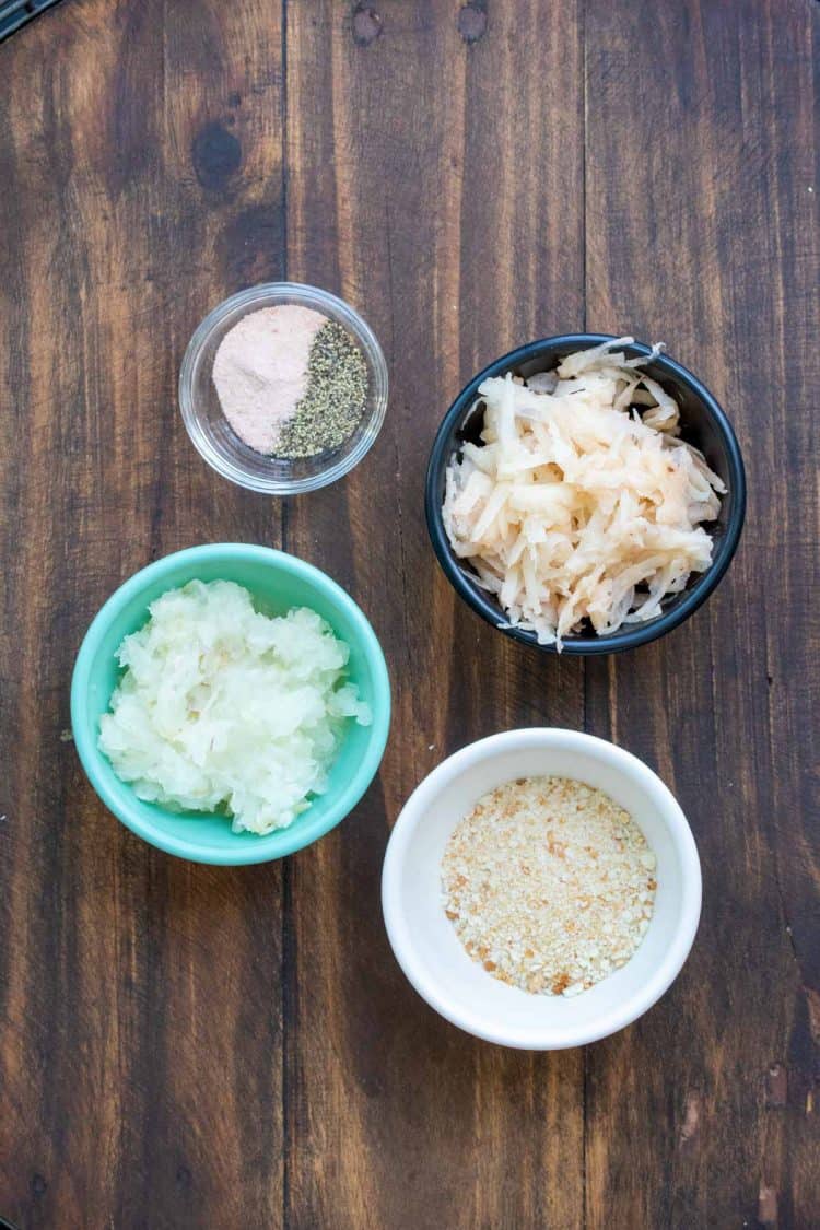 Different colored bowls filled with ingredients for latkes