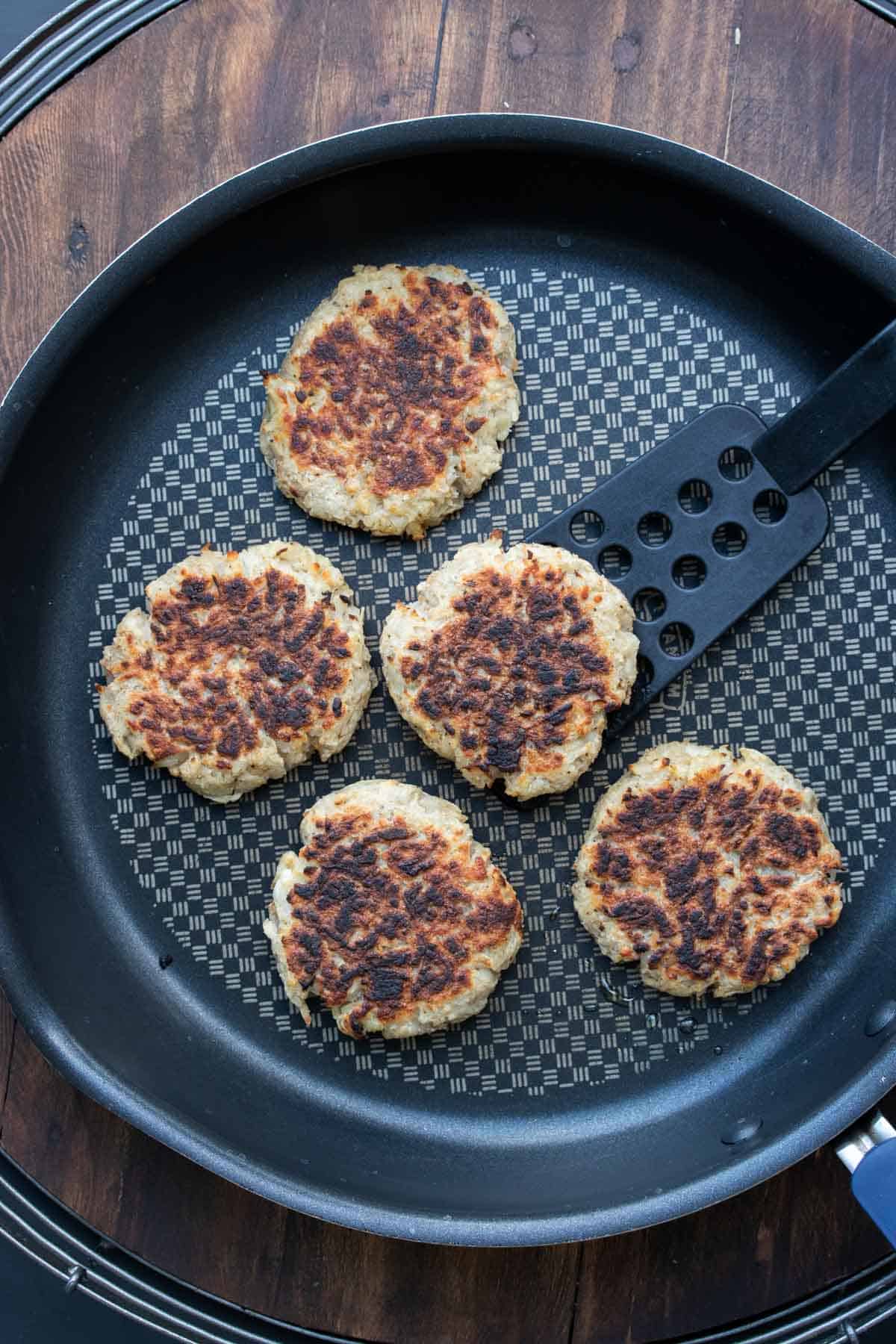 Potato pancakes being grilled on a pan