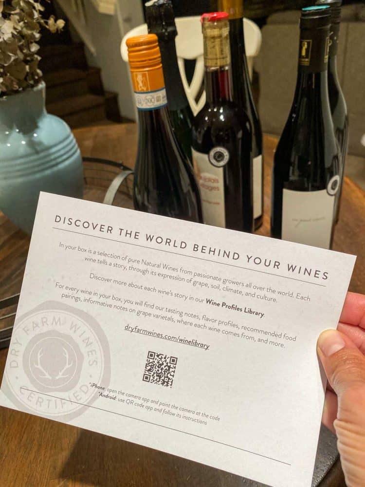 Hand holding an information card on dry farmed wines