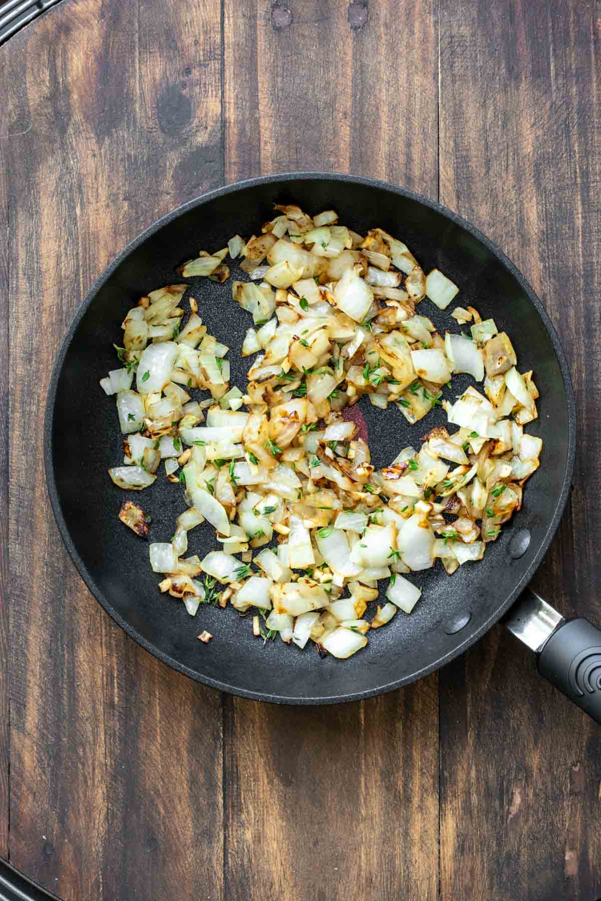 Pan with sautéed onions being cooked inside.