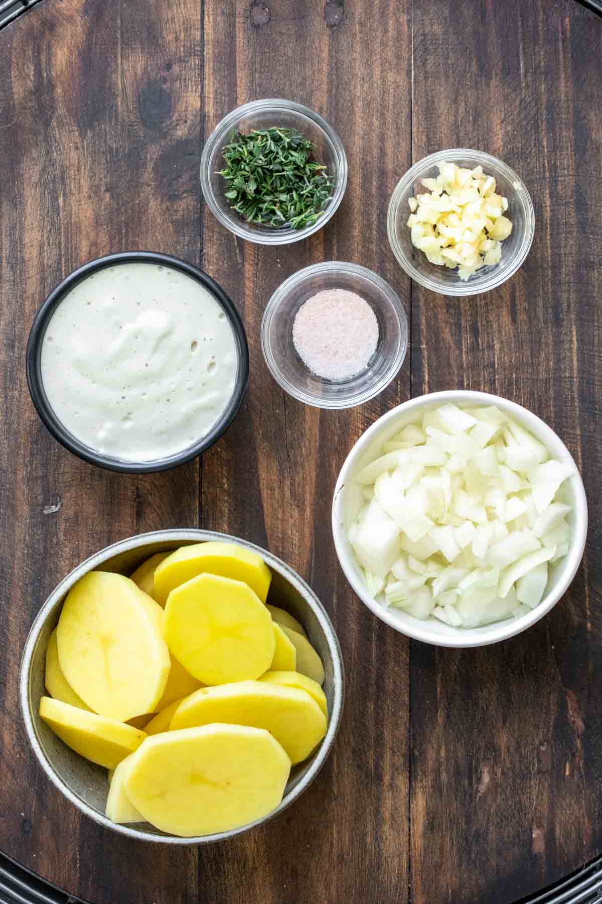 Different colored bowl with ingredients to make vegan scalloped potatoes