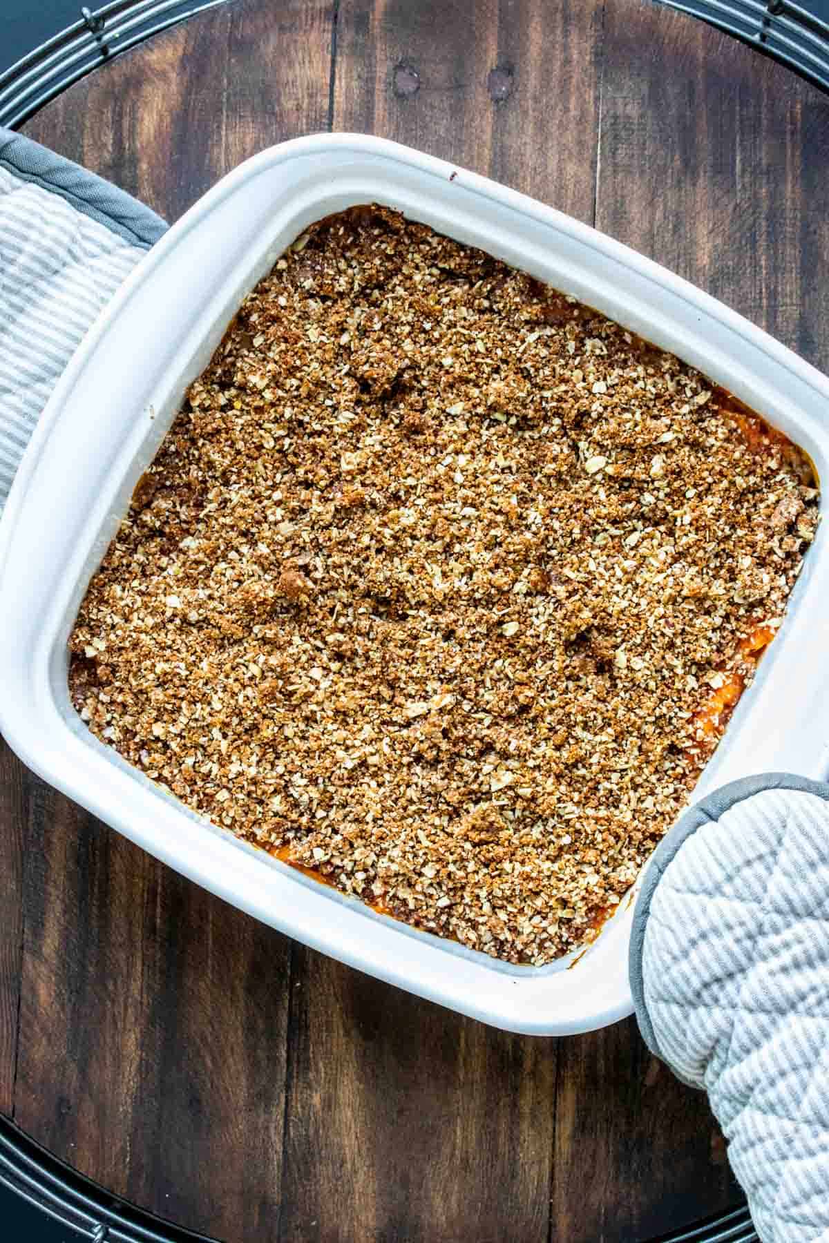 White baking dish with a baked sweet potato casserole in it.
