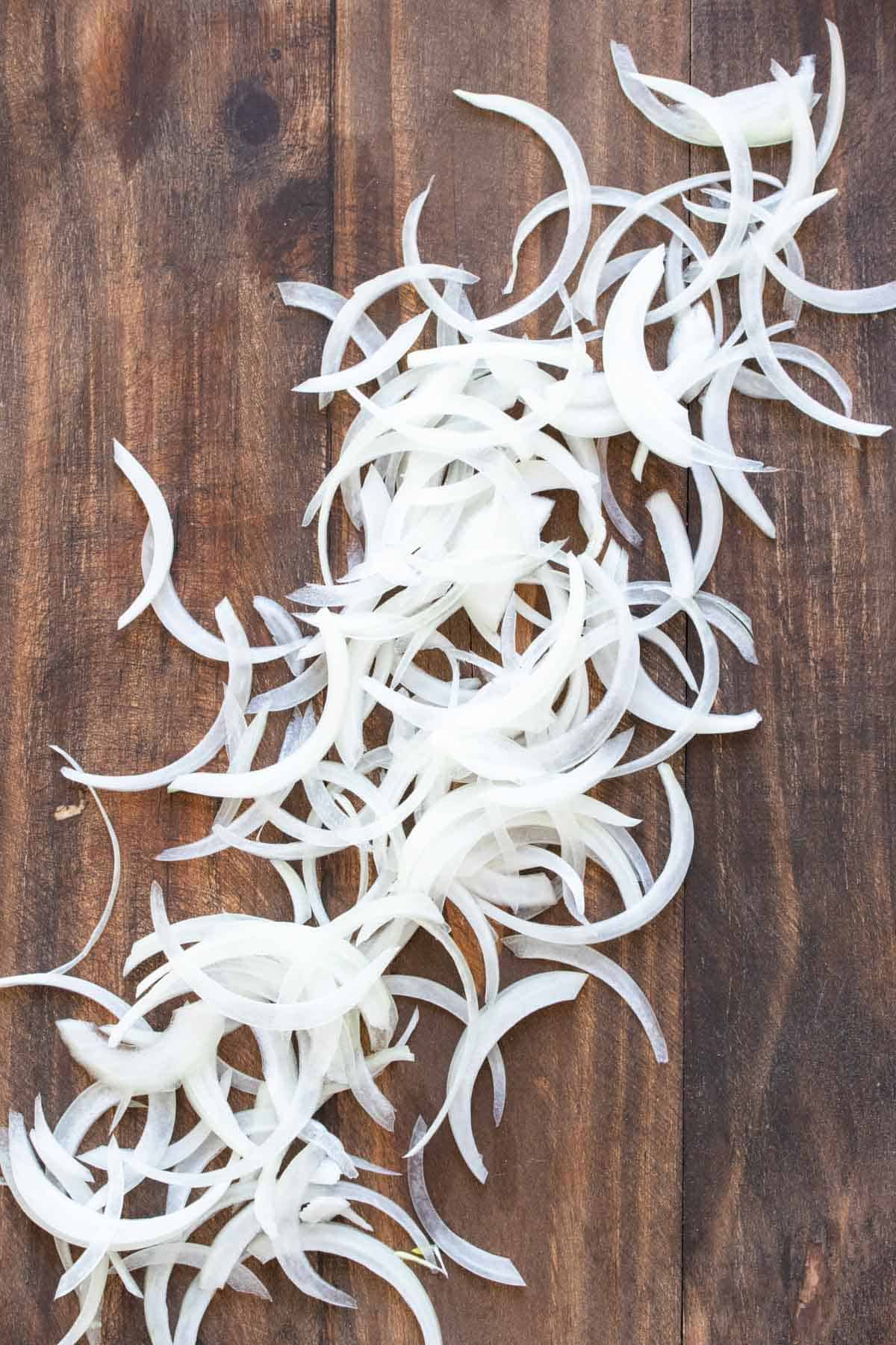 Sliced onions on a wooden surface