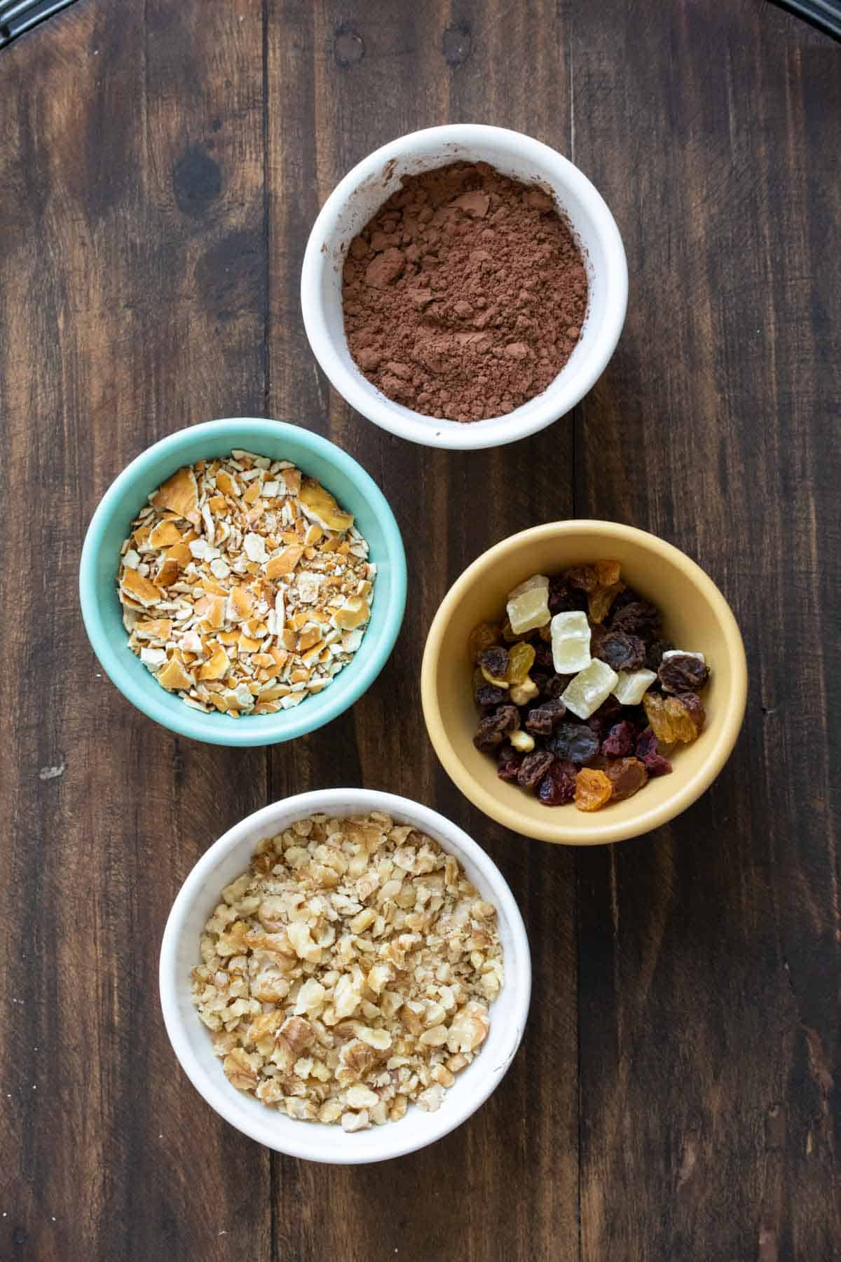 Bowls with different toppings for chocolate truffles.