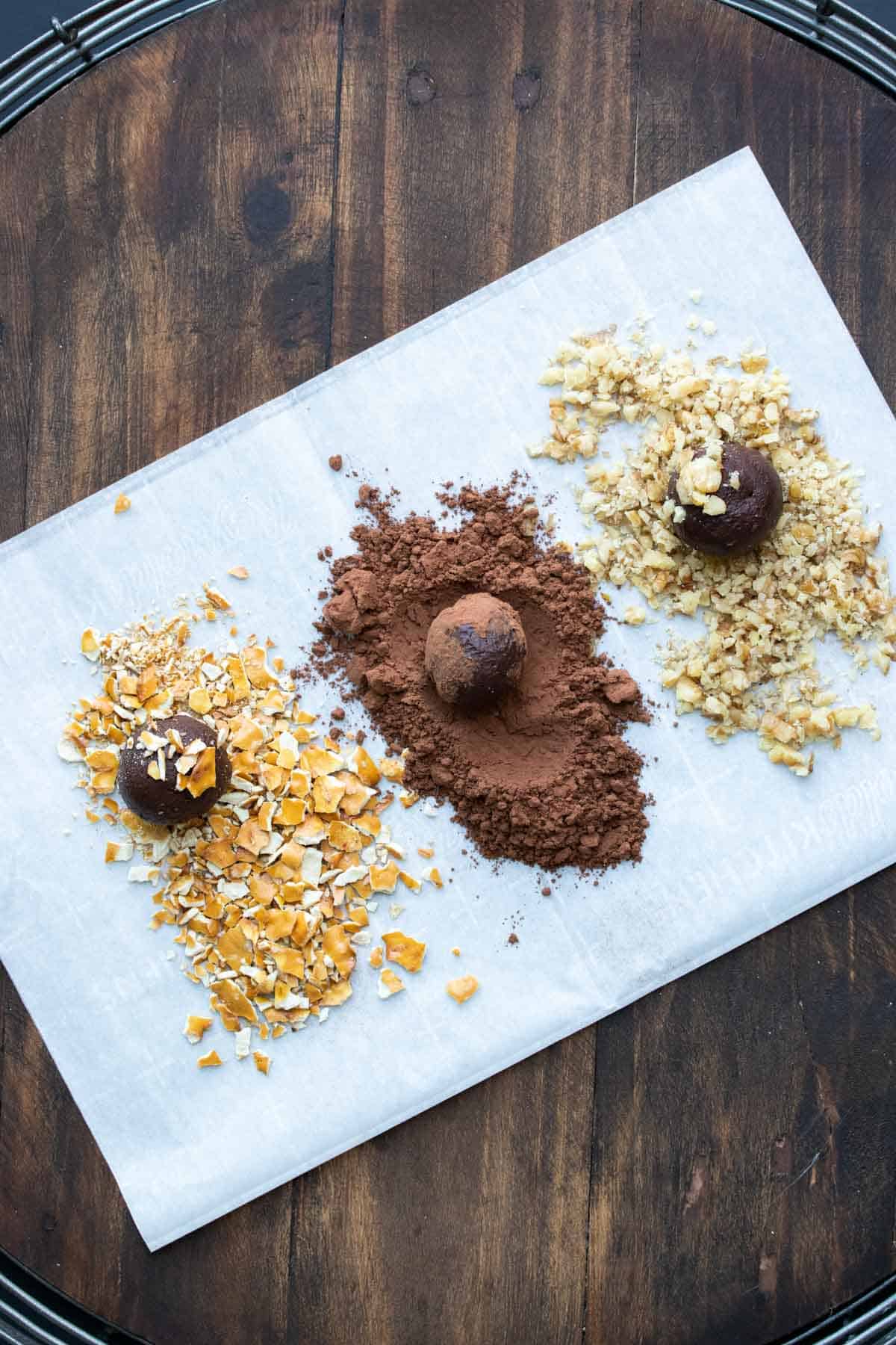 Piles of toppings with chocolate truffles being rolled in them