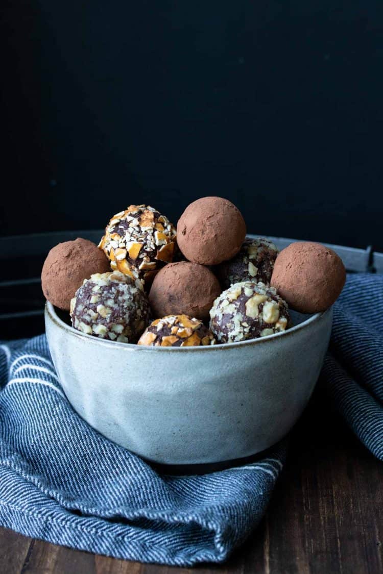 A pile of chocolate truffles in a grey bowl