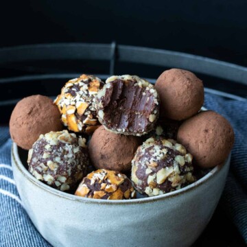 Half bitten chocolate truffle on a pile of other ones