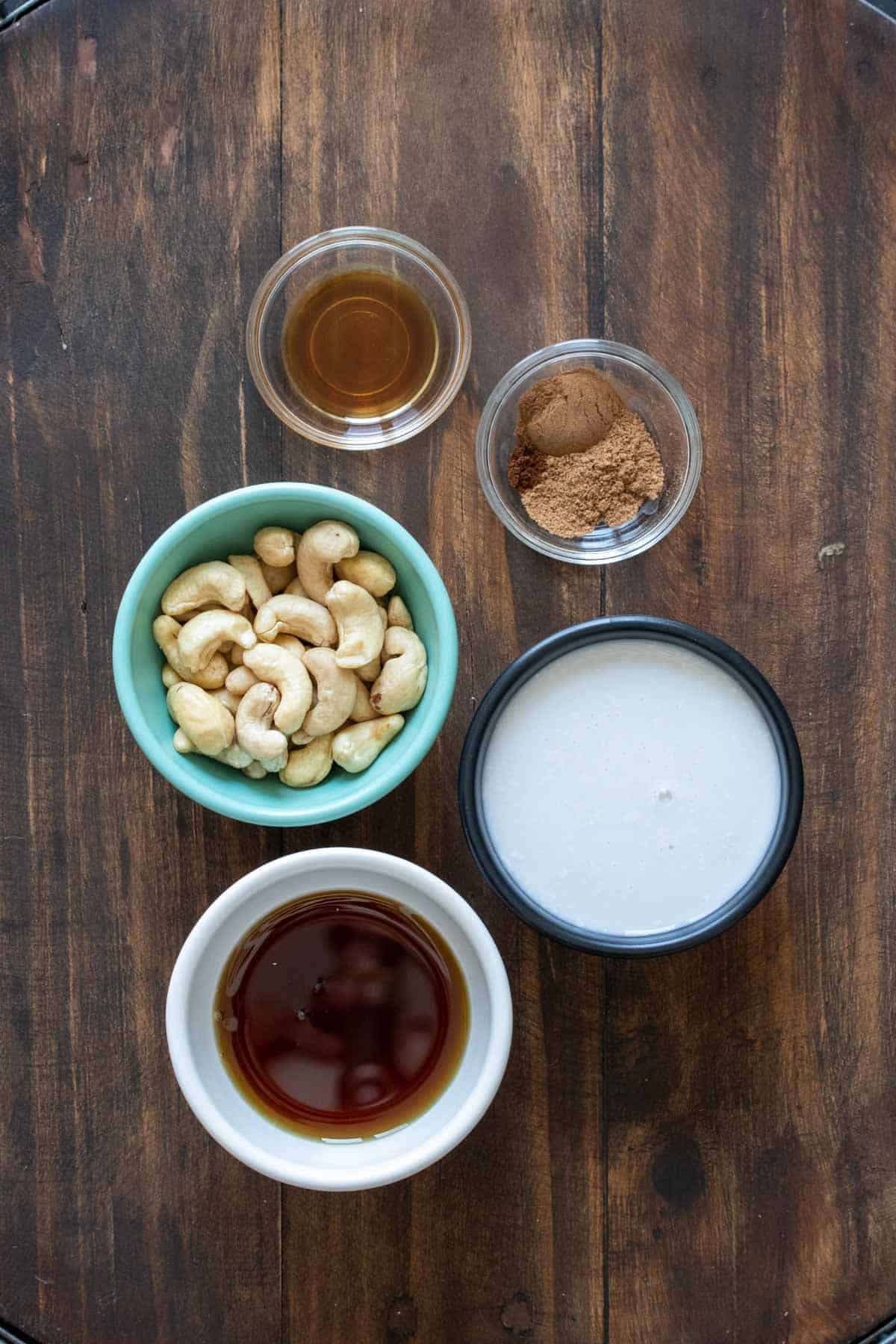 Different color bowls with ingredients to make homemade eggnog