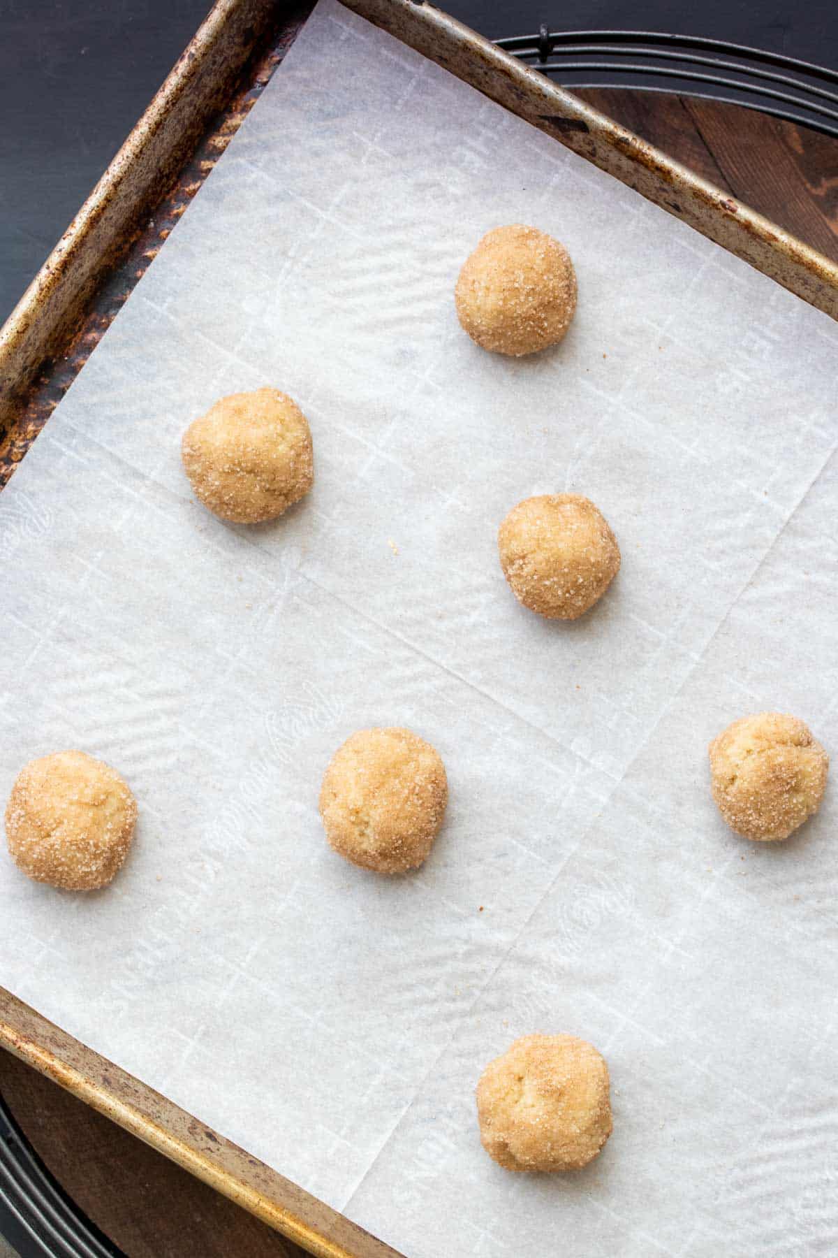 Cookie sheet with raw balls of snickerdoodles ready to be baked