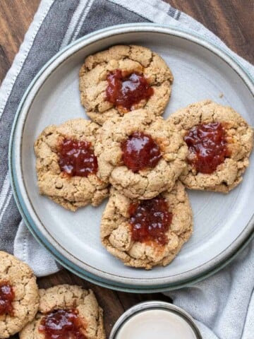 Grey plate with a pile of jam filled thumbprint cookies