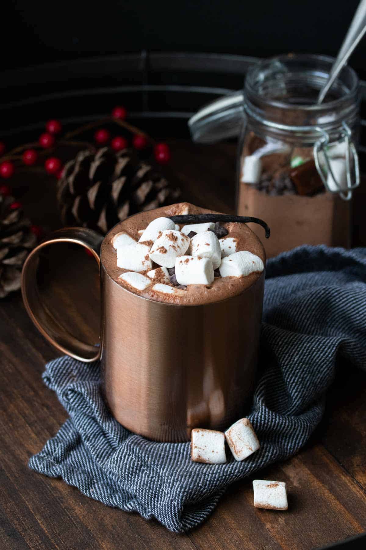 Copper mug with hot chocolate topped with marshmallows.