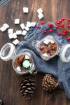 Top view of glass jars filled with hot cocoa mix and candies