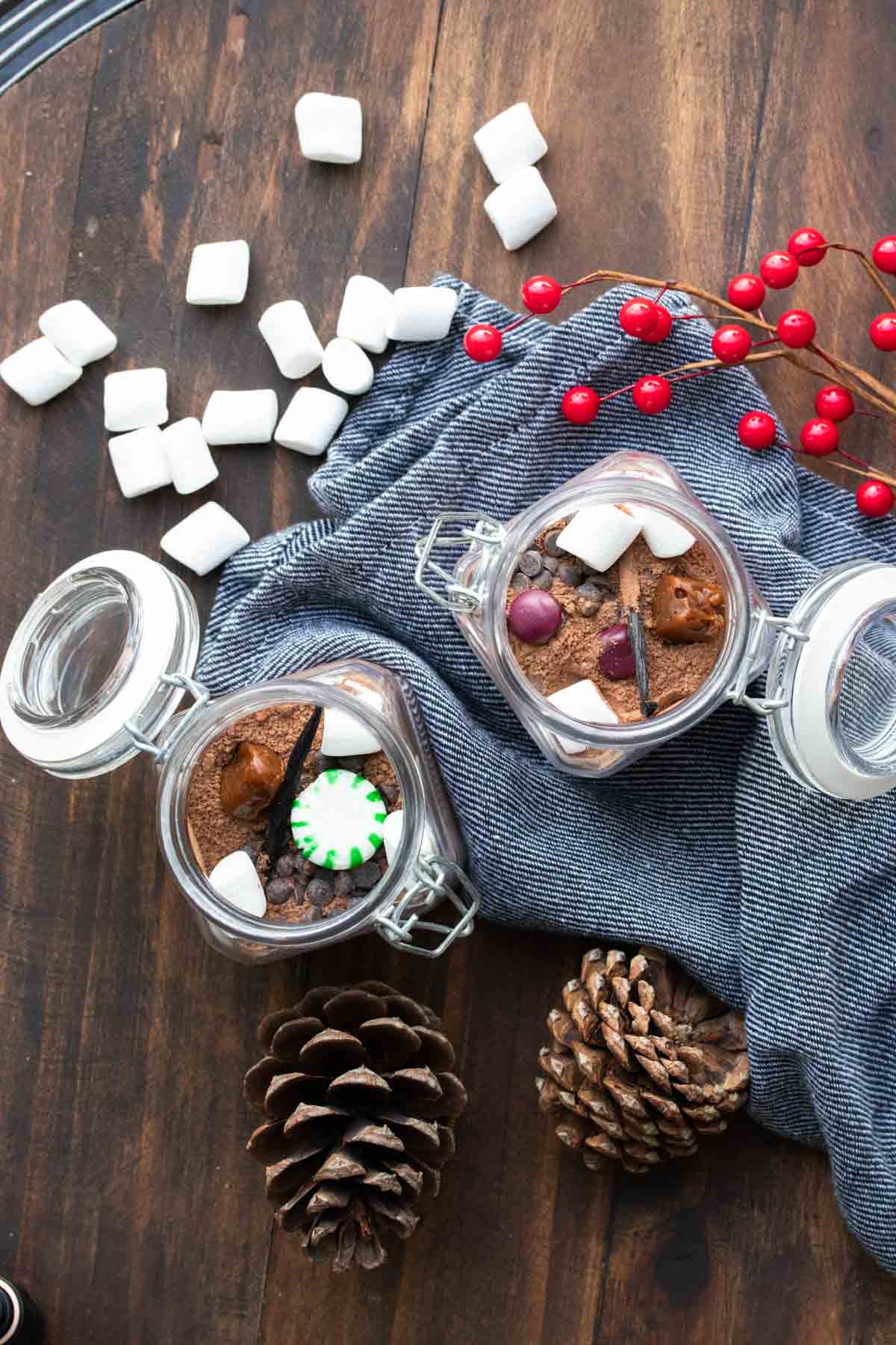 Top view of glass jars filled with hot cocoa mix and candies.