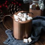 Copper mug filled with hot chocolate and topped marshmallows.