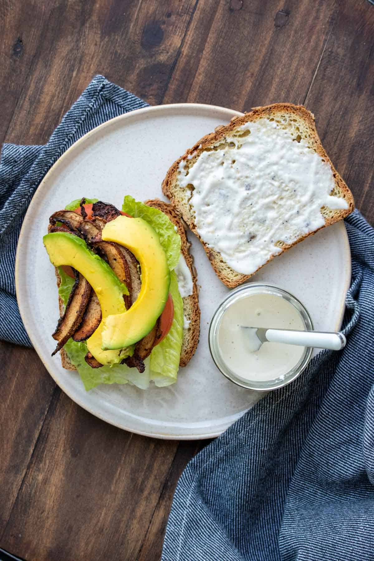 A vegan BLT being put together on a plate