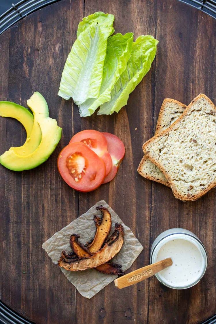 Top view of ingredients to make a vegan BLT on a wooden surface