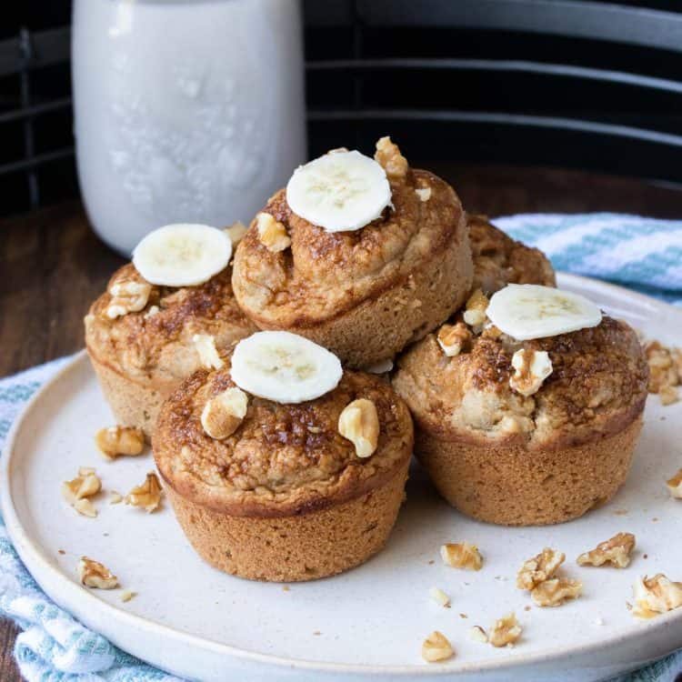 A plate with a pile of banana walnut muffins on it