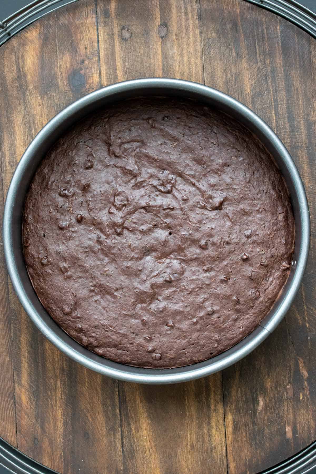 A round chocolate cake baked in a pan