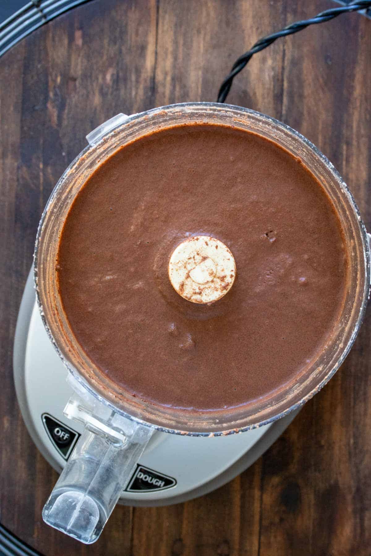 Top view of a food processor with chocolate batter inside