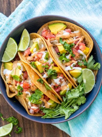 Dark blue bowl filled with three potato tacos