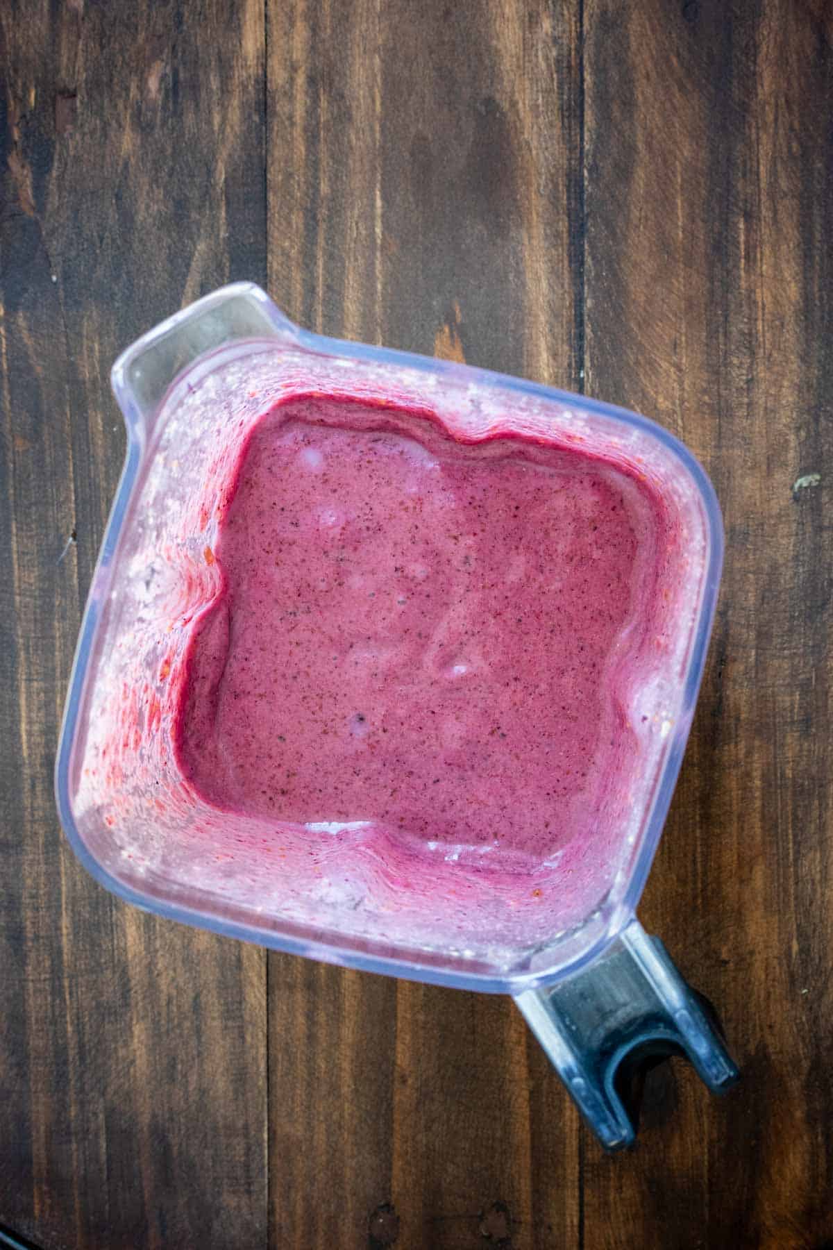 Top view of a blender with a purple smoothie inside