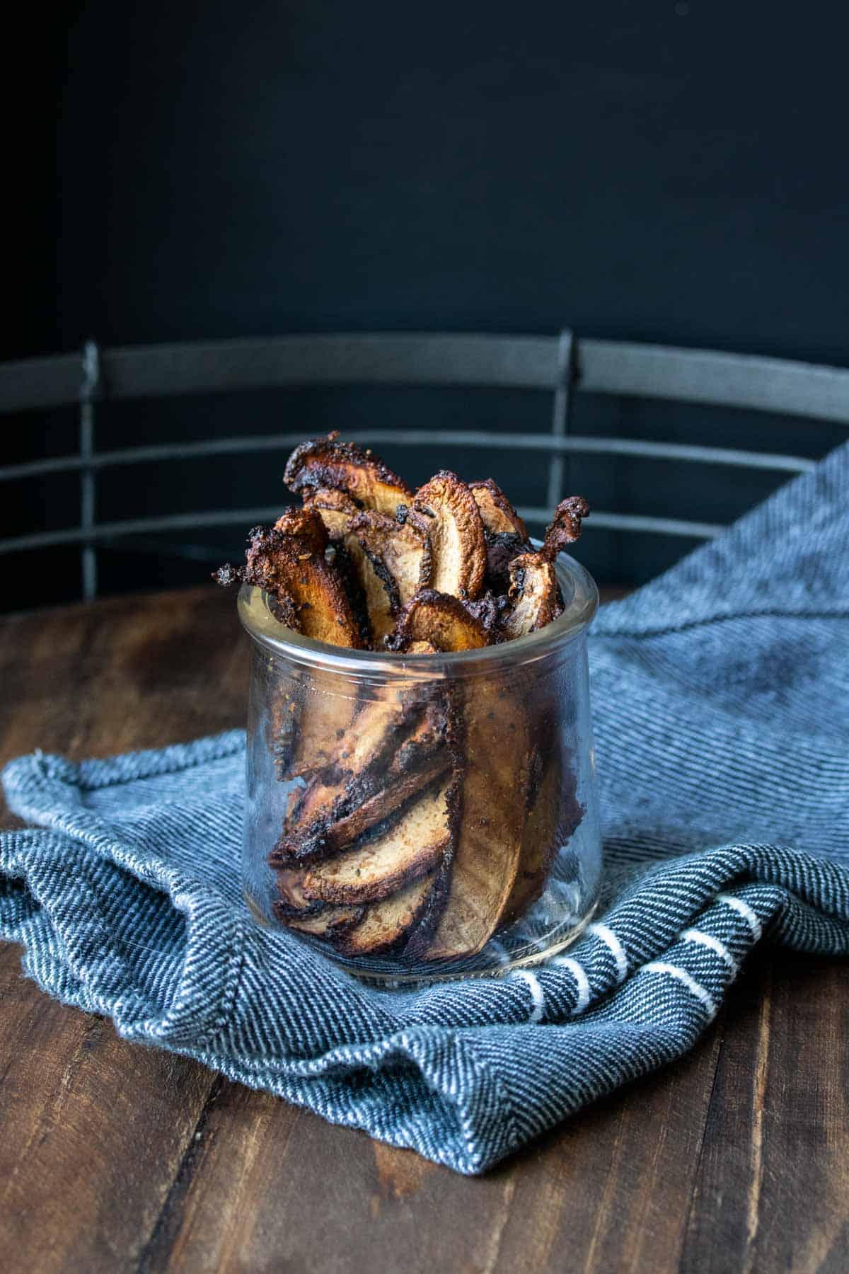 Crispy baked slices of portobello mushroom in a glass jar