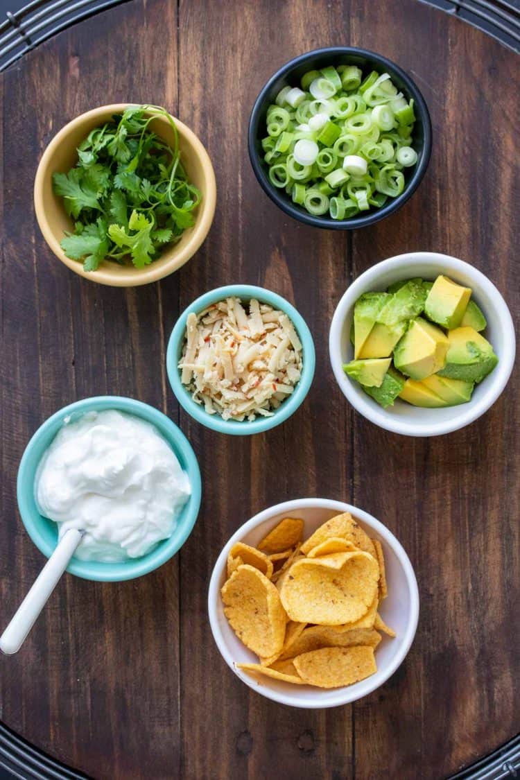 Bowls filled with ingredients for chili toppings