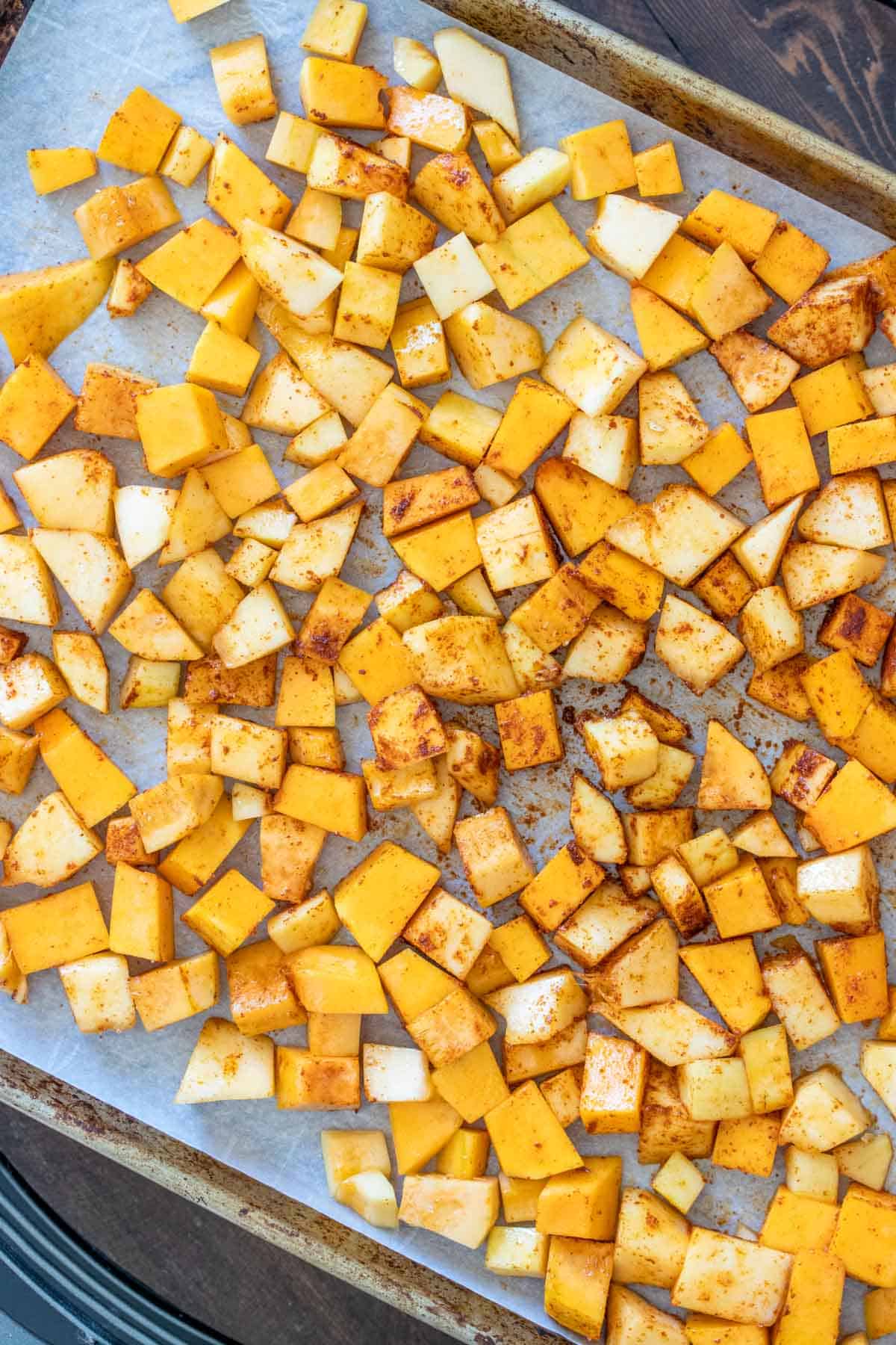 Top view of roasted butternut squash pieces on a baking sheet