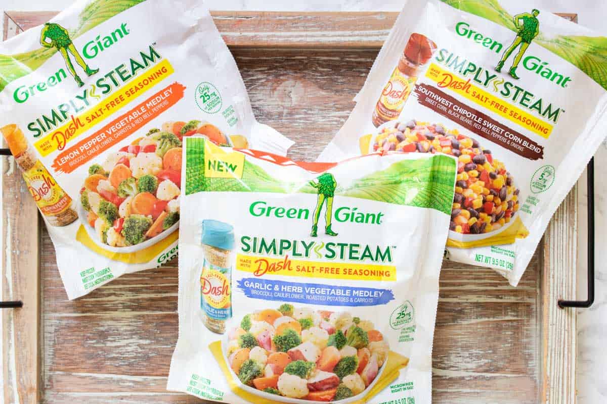 Three white packages of frozen veggie mixes from Green Giant