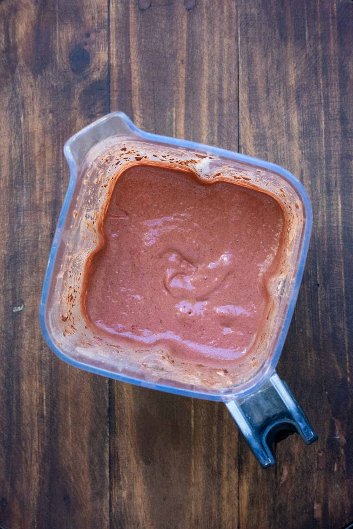 Top view of a blender filled with a chocolate strawberry smoothie