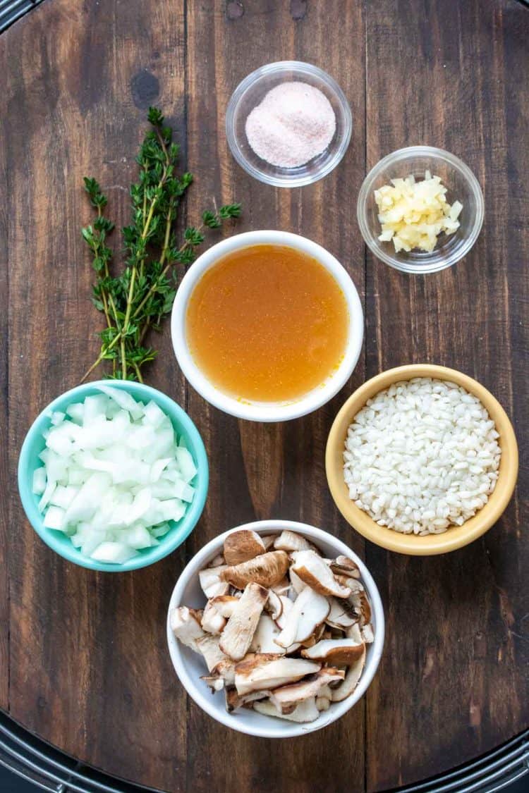 Bowls filled with ingredients to make a vegan mushroom risotto.