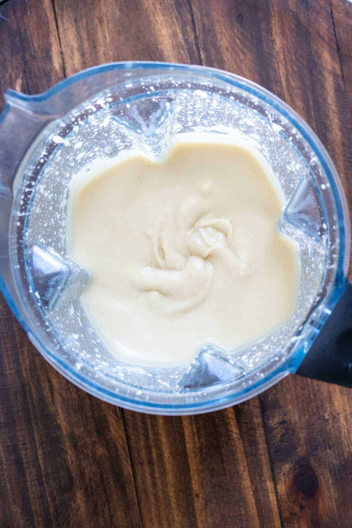 Top view of a blender with a cream cheese frosting inside