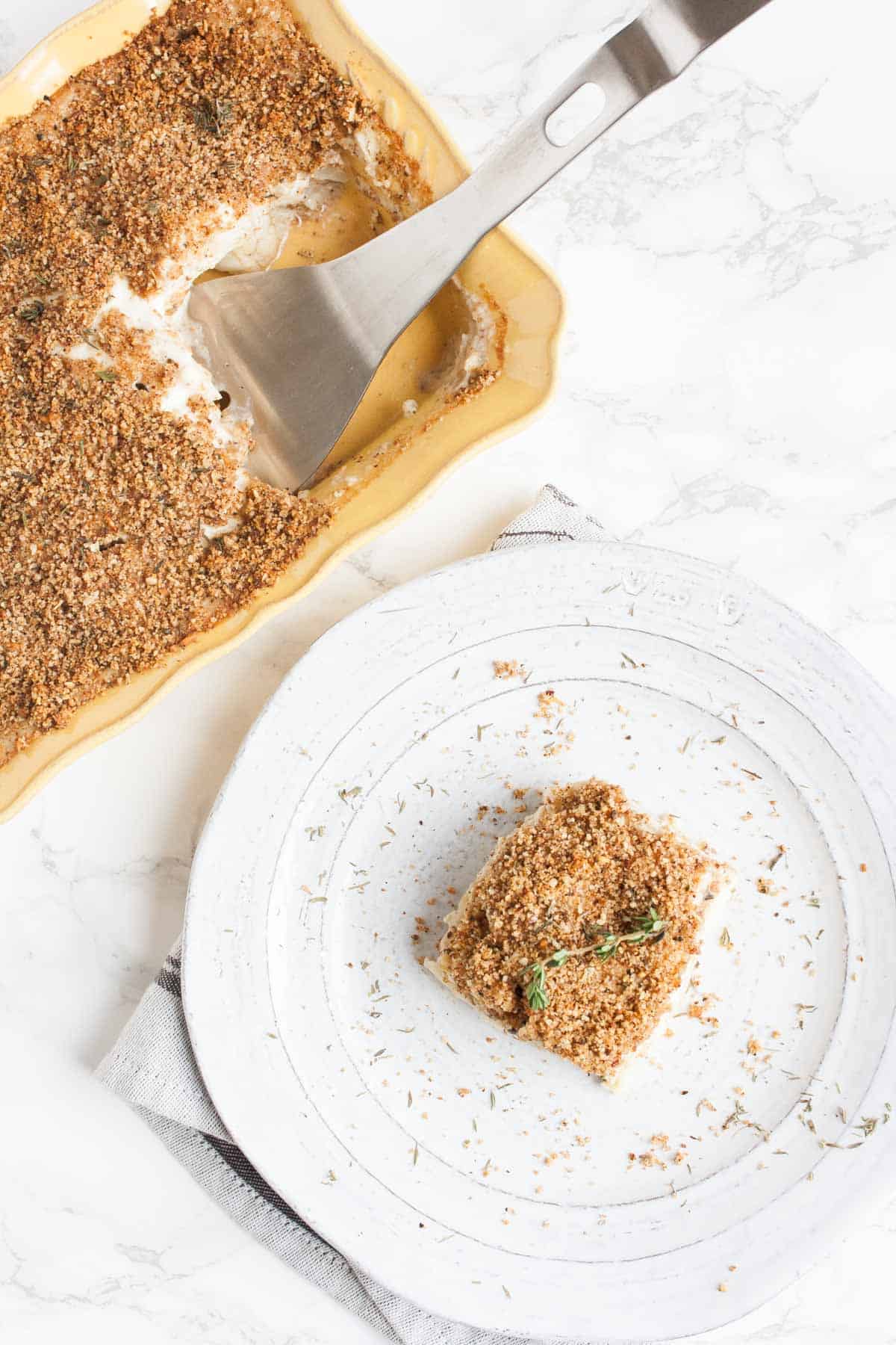 Top view of a baked cauliflower casserole in a yellow baking dish.