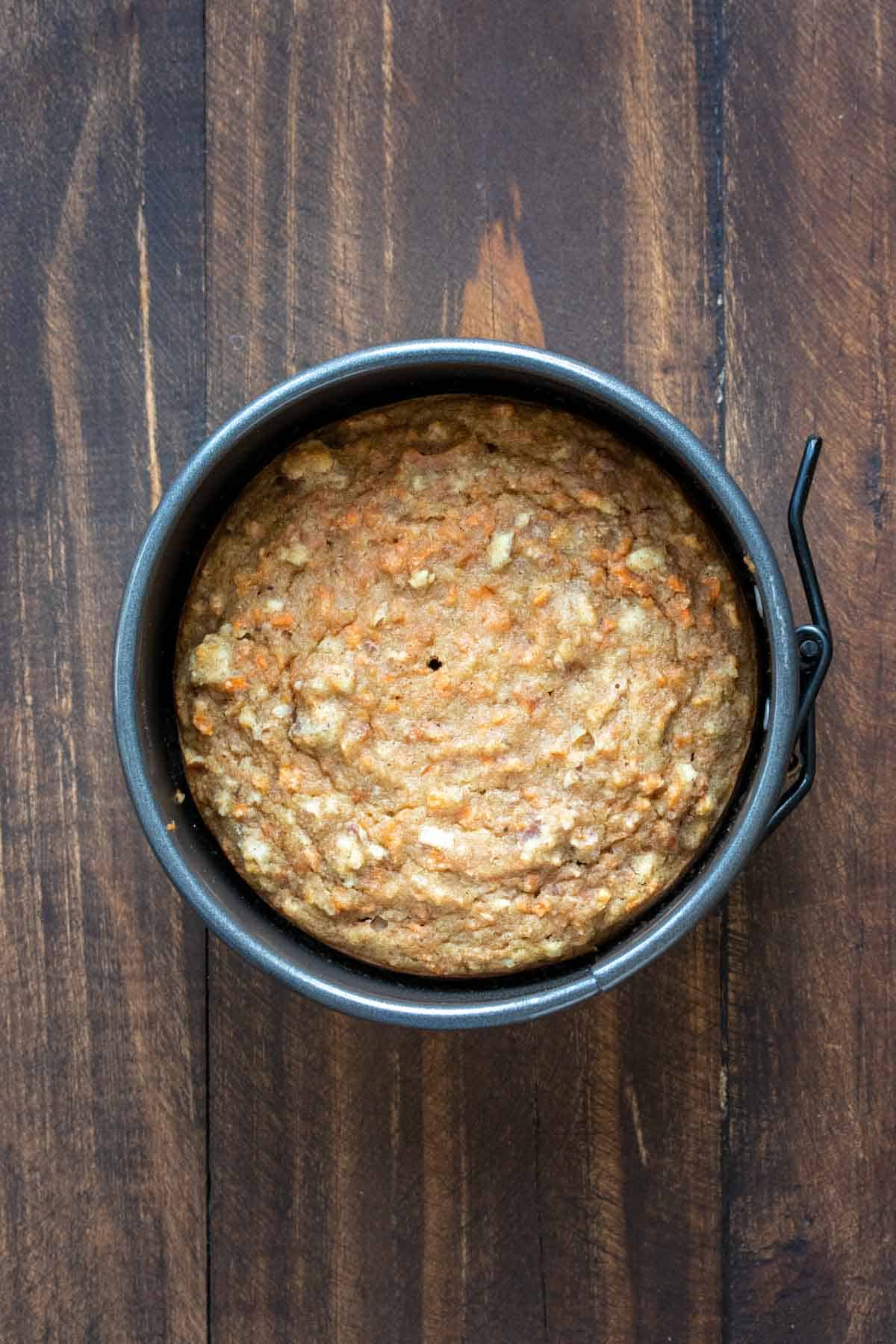 A baked carrot cake in a round cake pan