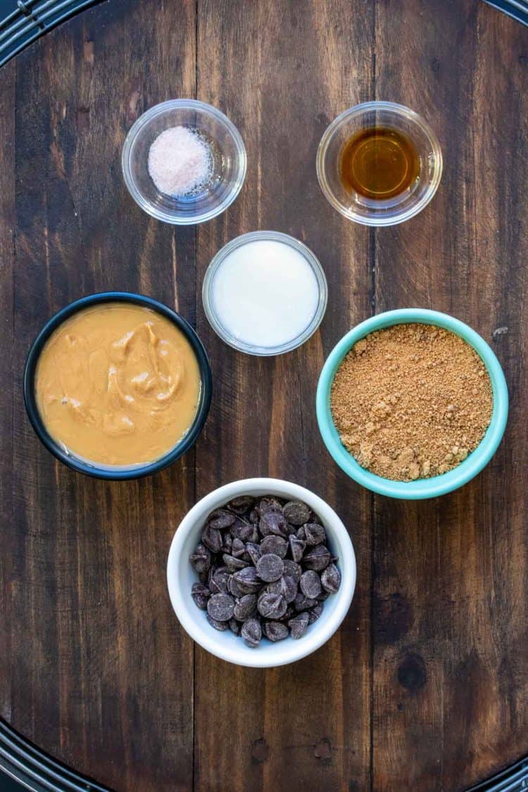 Different colored bowls filled with ingredients to make peanut butter cups