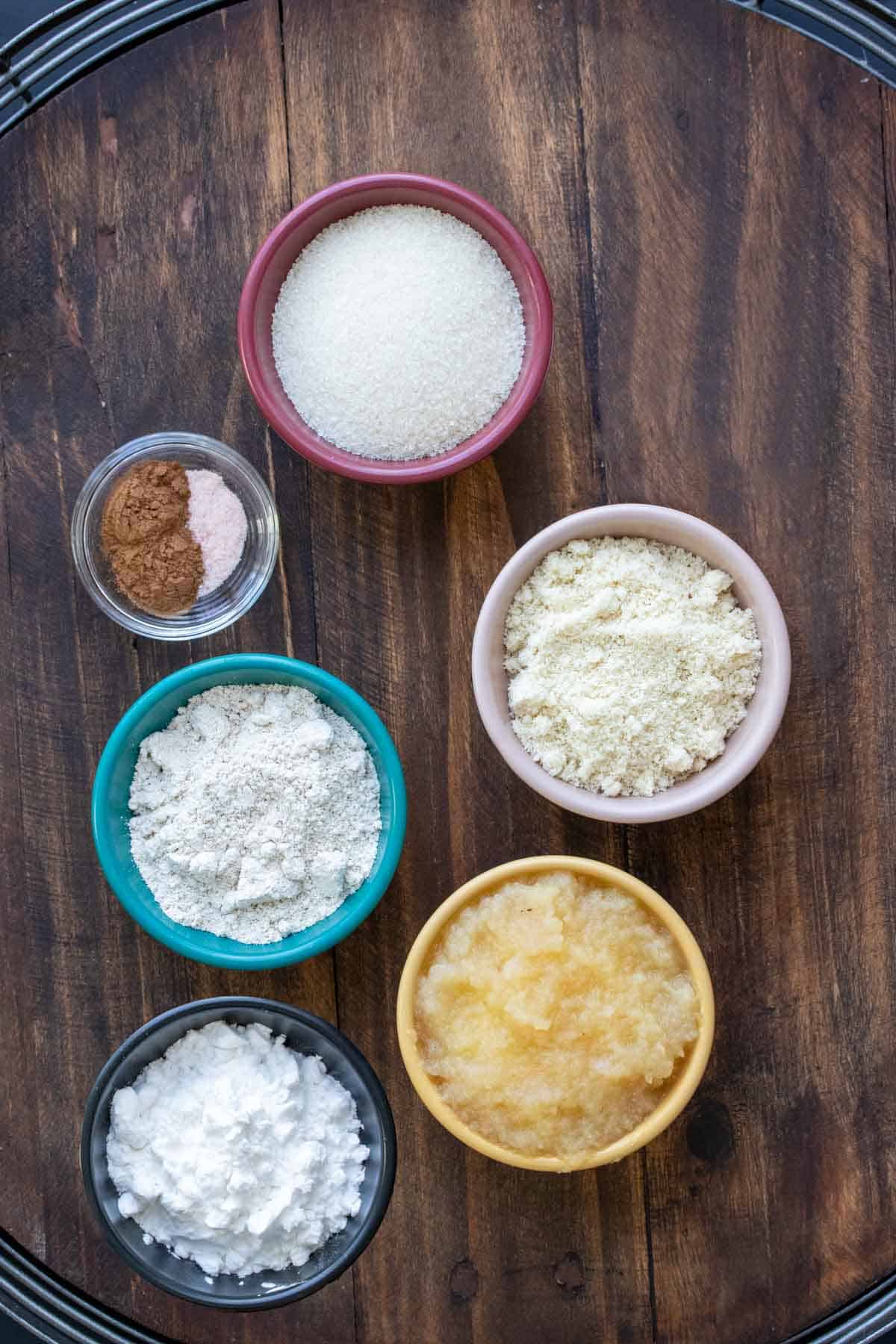 Different colored bowls filled with ingredients to make vegan churros.