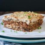 White plate with a piece of lentil based moussaka on it.