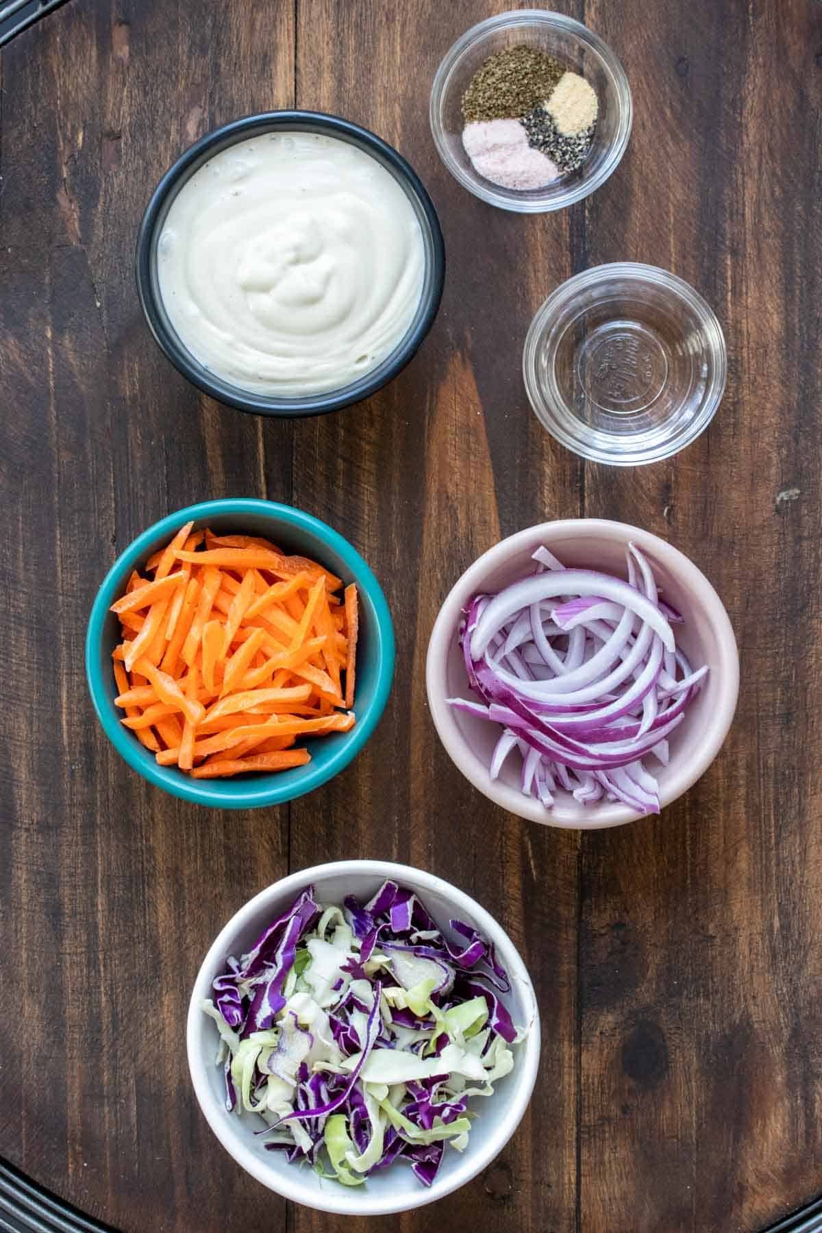 Bowls with ingredients needed to make coleslaw.