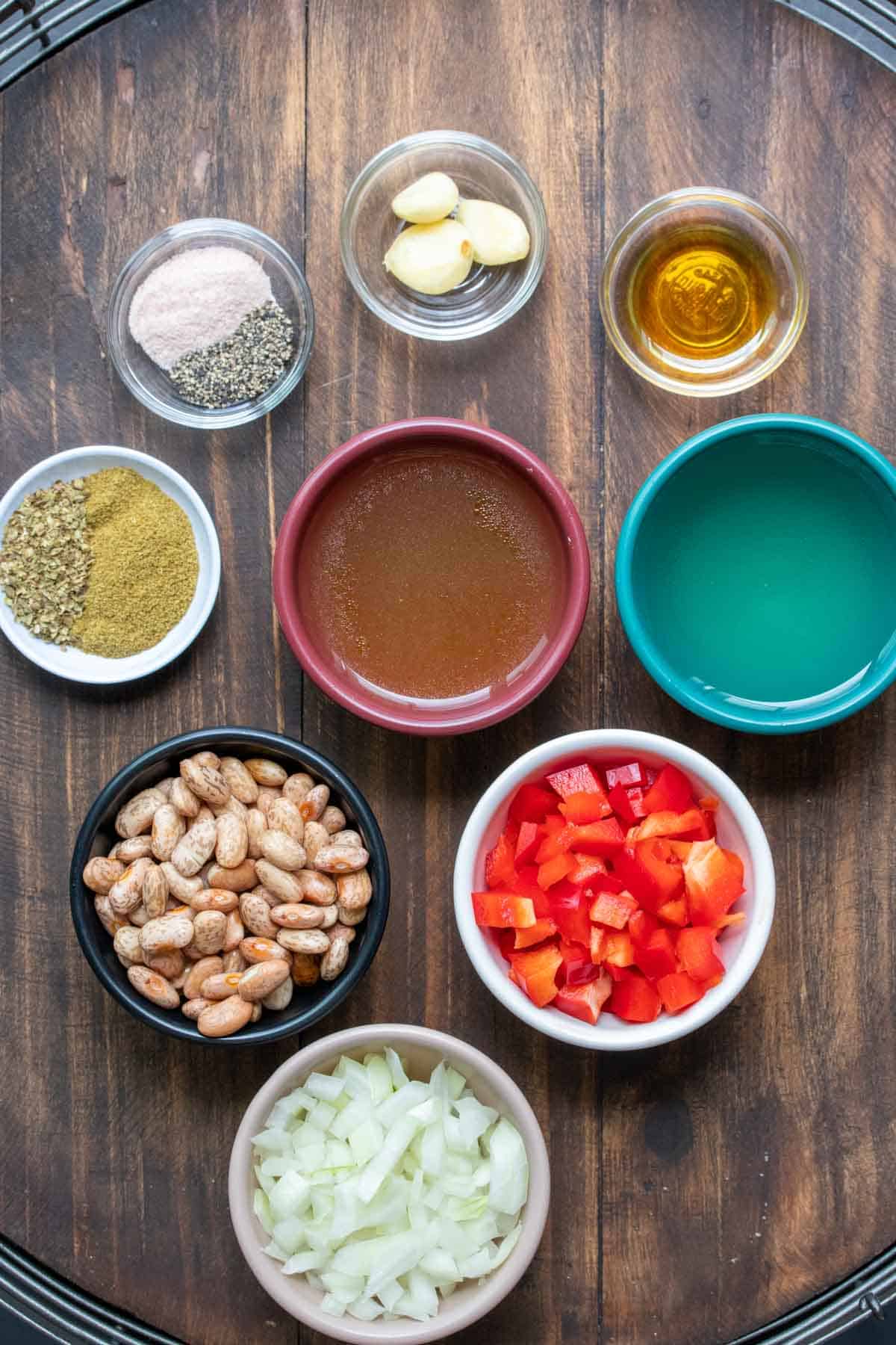 Different colored bowls filled with ingredients to make homemade pinto beans