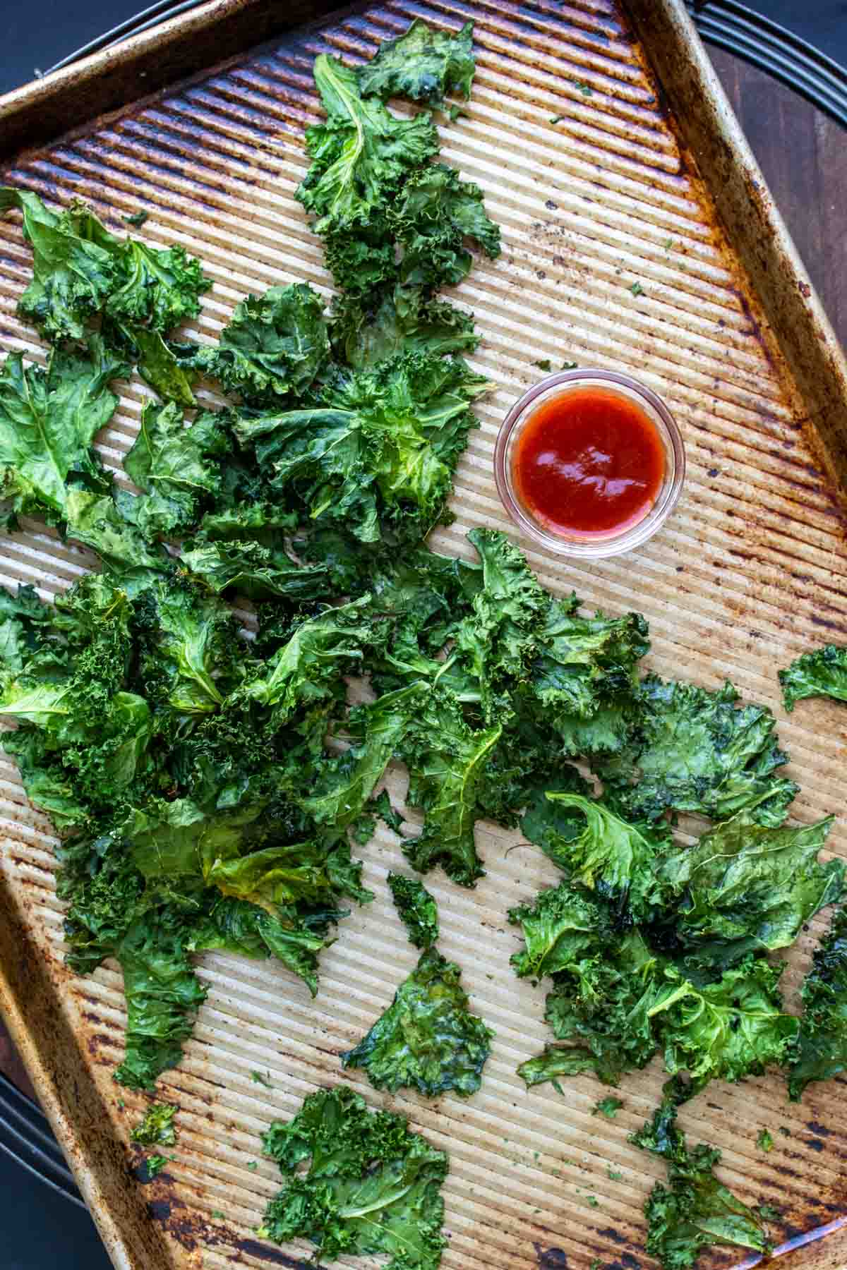 Baking sheet with a pile of kale chips on it