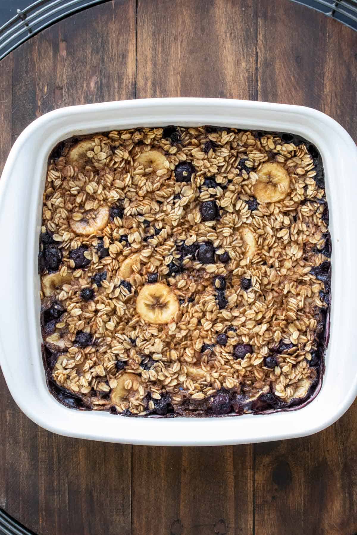 Baked blueberry and banana oatmeal in a white baking dish