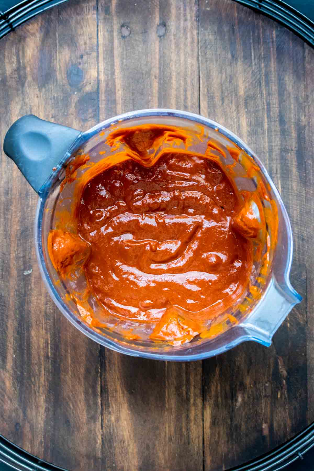 Top view of a blender with red sauce inside