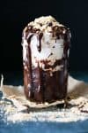 Glass jar with a chocolate mug cake topped with marshmallows and grahams