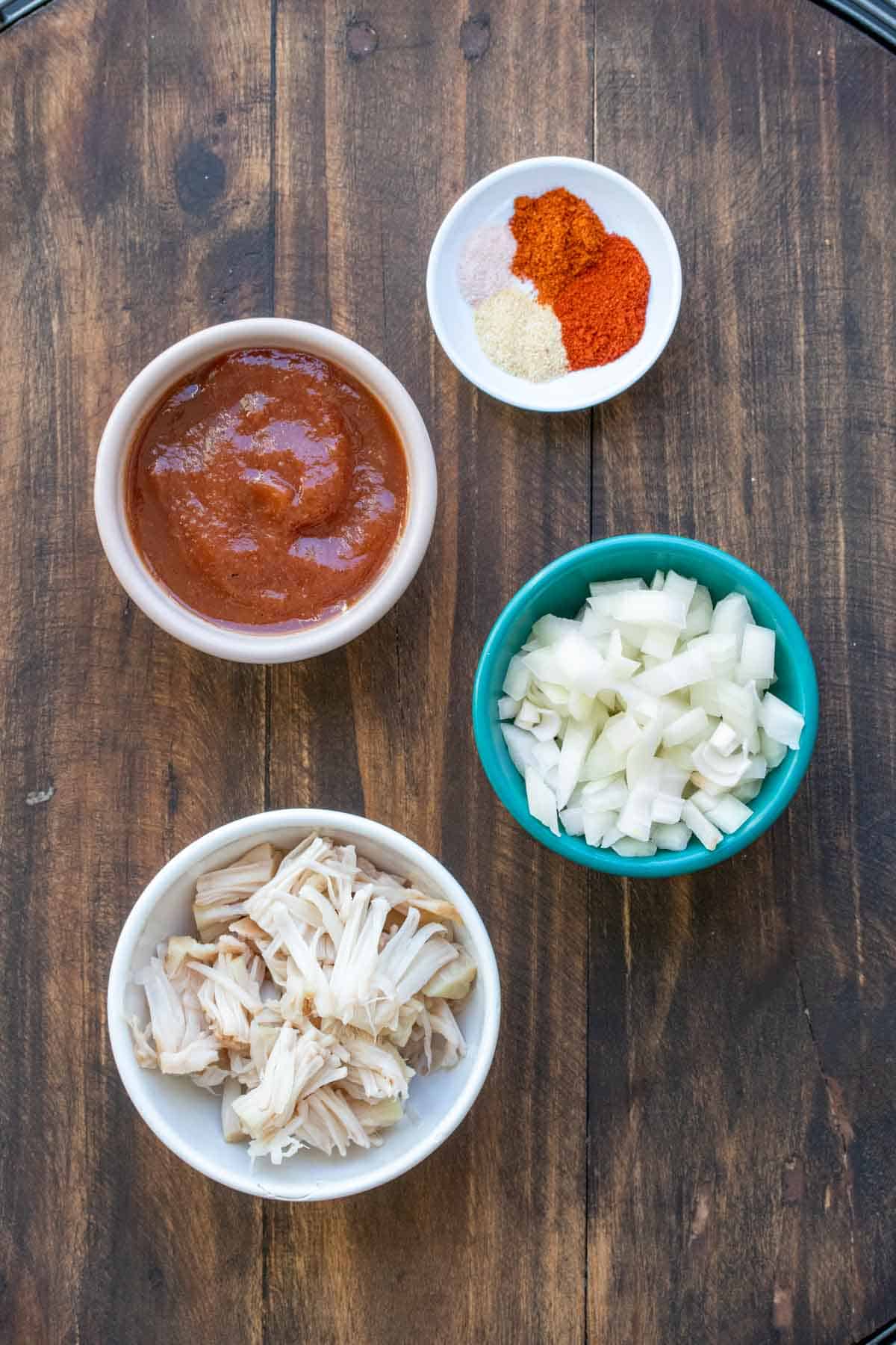 Bowls filled with jackfruit, BBQ sauce, onions and spices