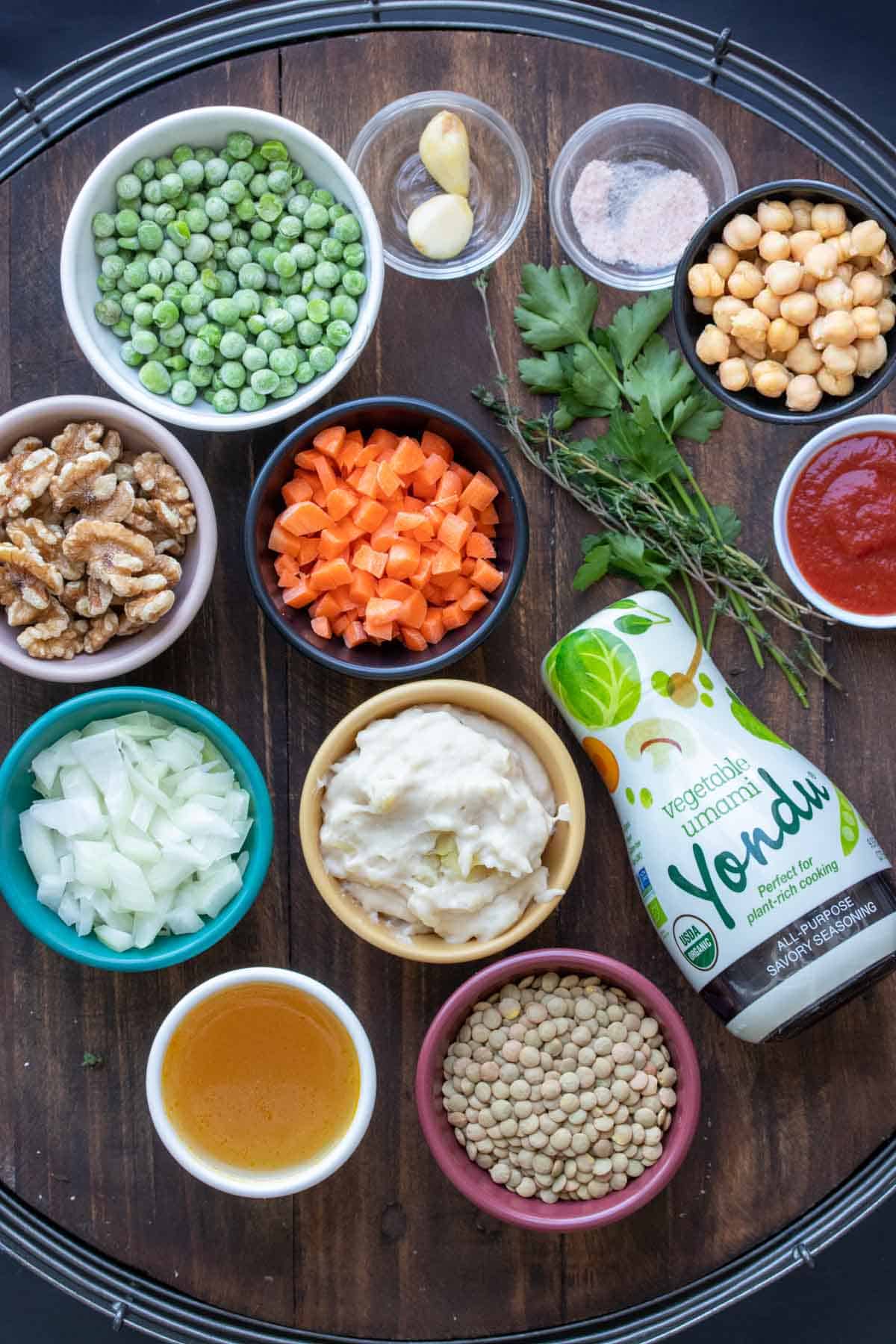 Different colored bowls filled with ingredients to make a vegan Shepherd’s pie.