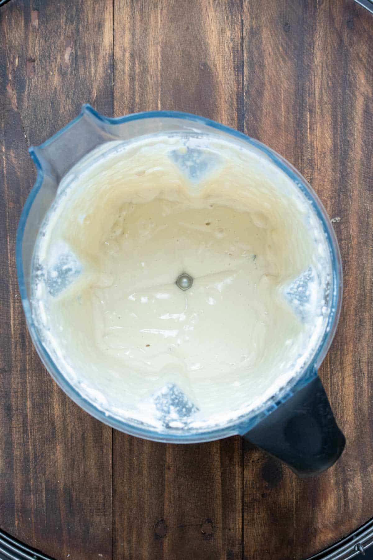 Top view of a blender with creamy sauce inside