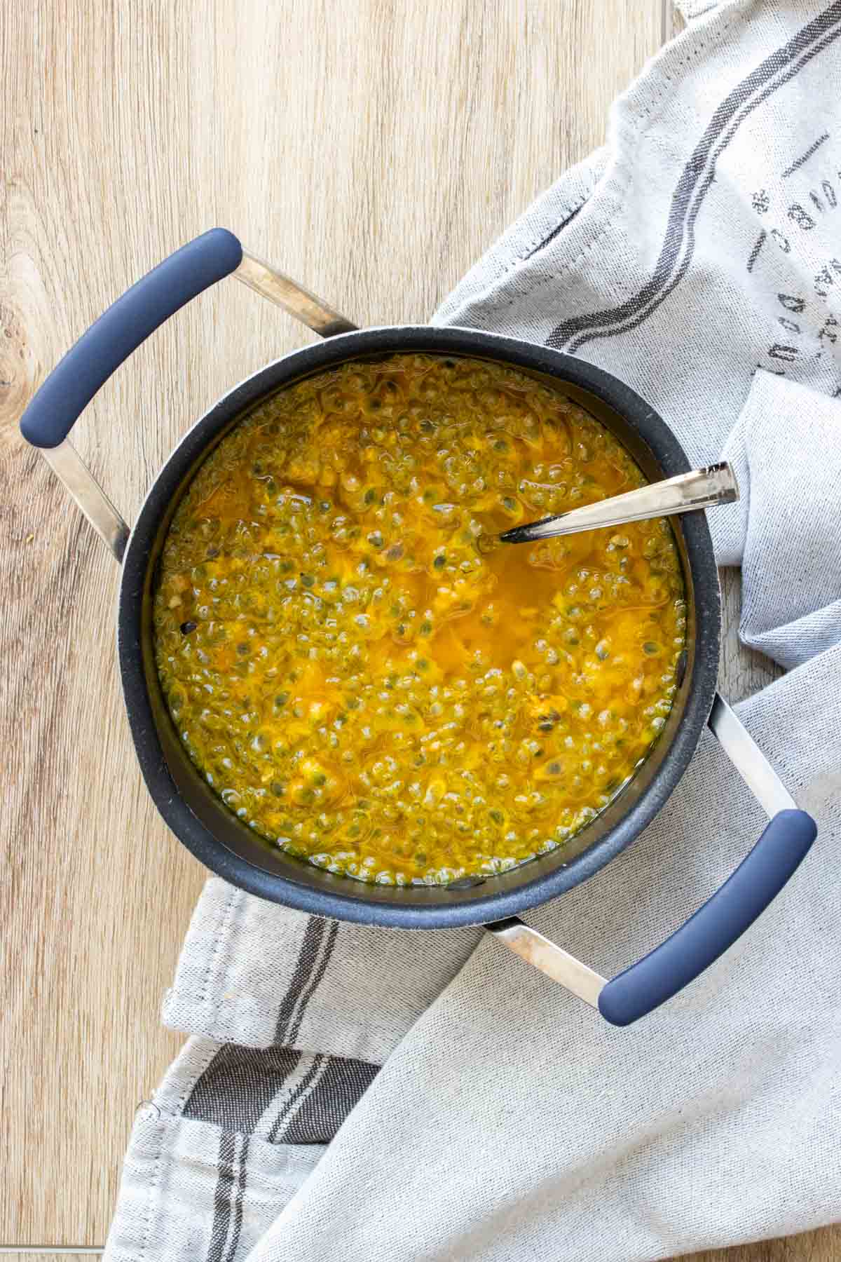 Top view of a pot with a liquid with passion fruit inside