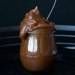 Spoon in glass jar overfilled with date past